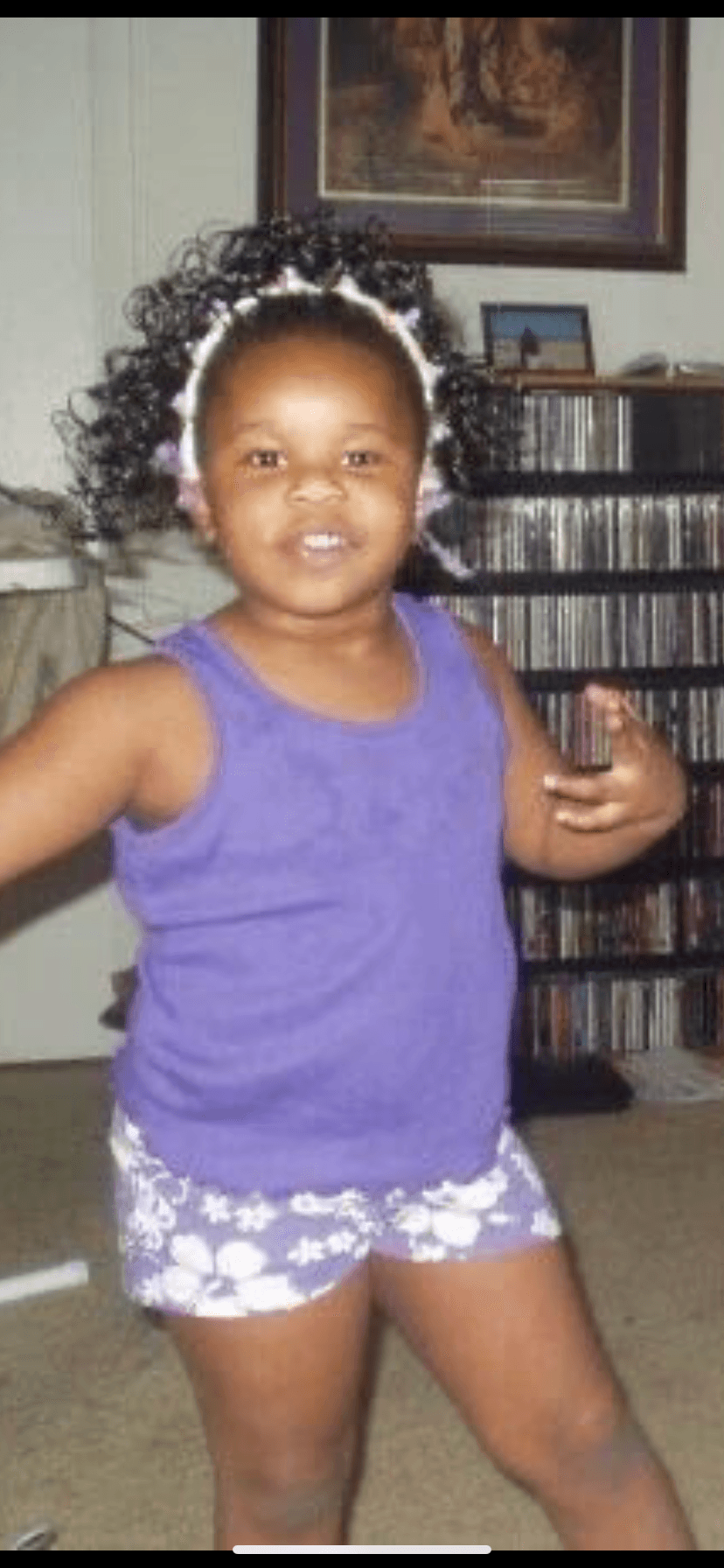 Shayna Vincent as a young child wearing purple